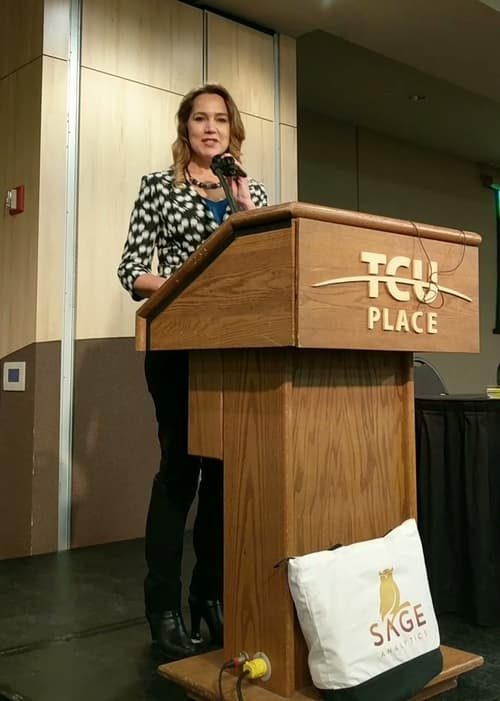 Shari-Anne Doolaege speaking at a podium